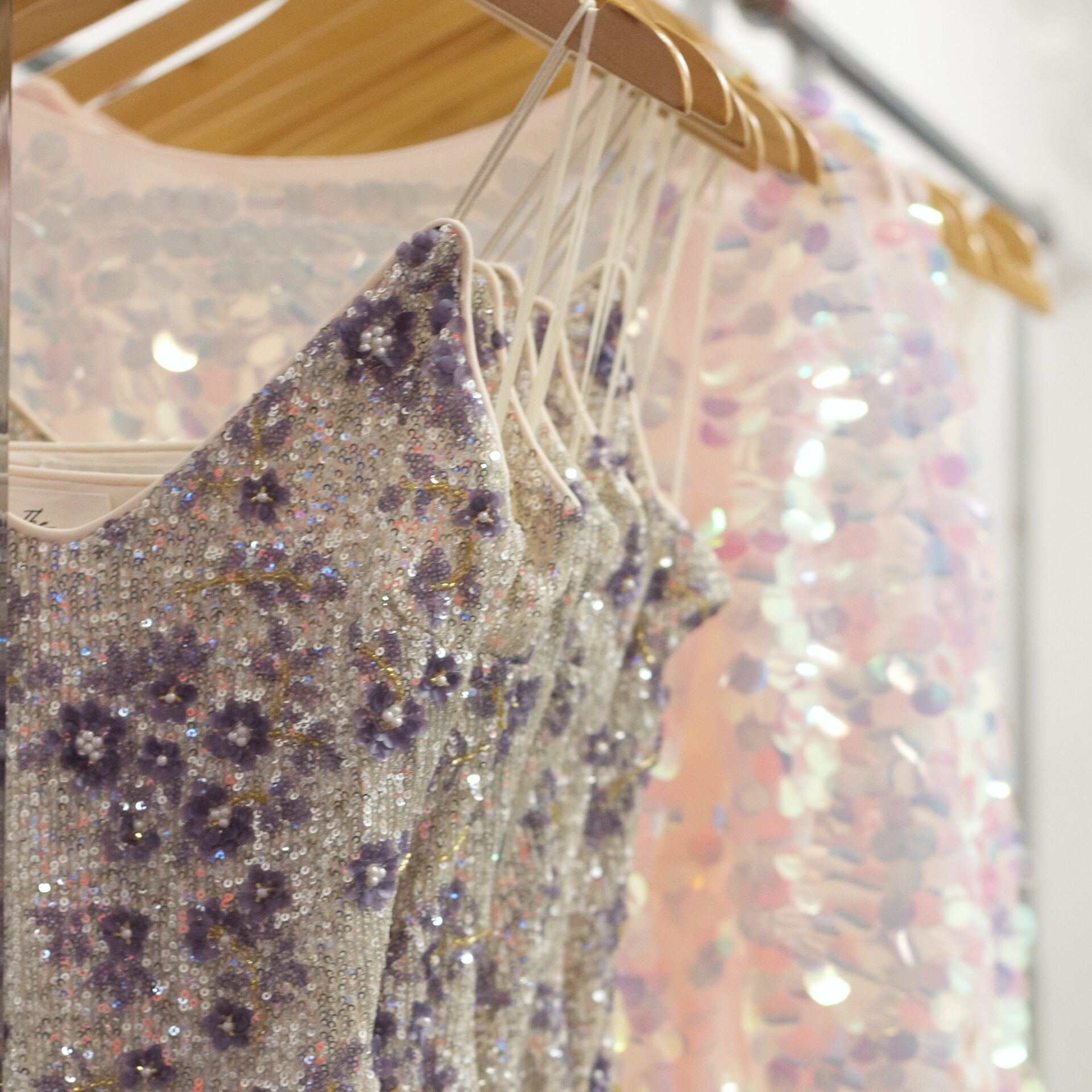 Beaded dresses on a rack.